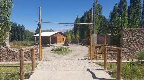an open gate to a building with a dirt road at Terrazas de Uspallata in Uspallata