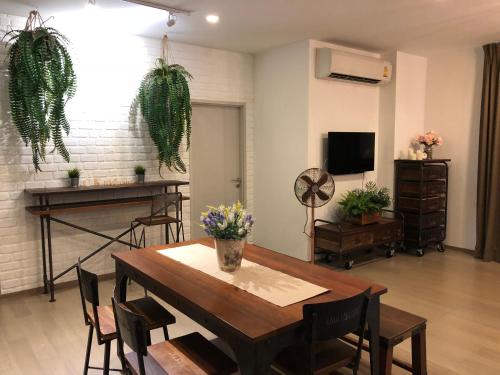 a dining room with a table and some plants at CK cottage @ Khao Yai in Pak Chong