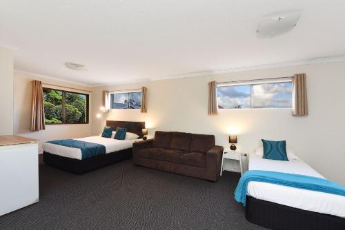 a hotel room with two beds and a couch at Motel in Nambour in Nambour