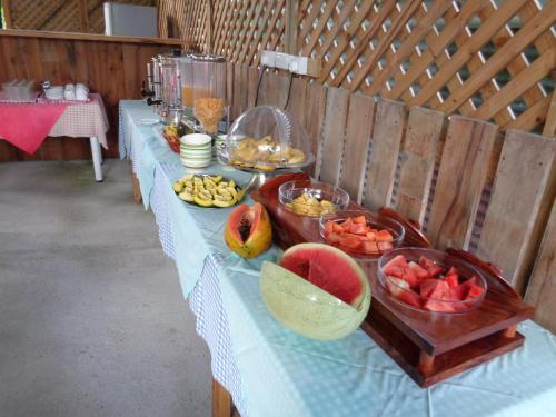 a long table with bowls of fruit on it at Chez Michellin Pensions Residence in La Digue