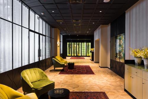 a lobby with chairs and tables in a building at Leonardo Boutique Jerusalem in Jerusalem