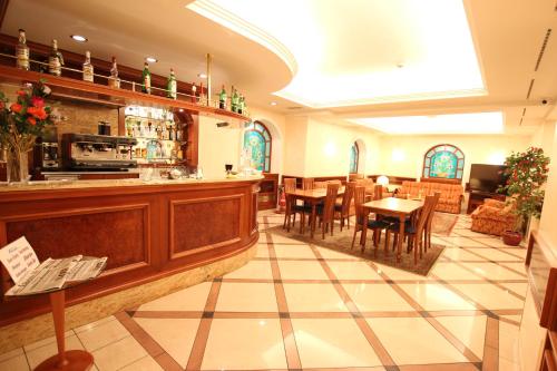 a restaurant with a bar and tables and chairs at Mokinba Hotels Montebianco in Milan