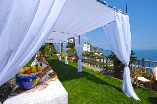 a marquee with a table with a bowl of fruit at Locanda Costa Diva in Praiano