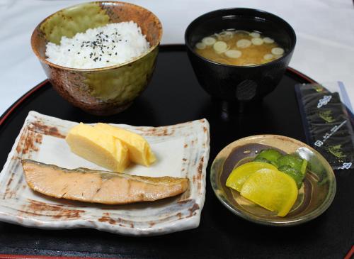 a tray with a plate of food and a bowl of soup at Hotel Sindbad Yamagata (Adult Only) in Higashine