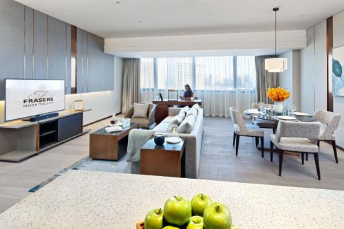 a living room with a couch and a table at Fraser Suites Dalian in Dalian