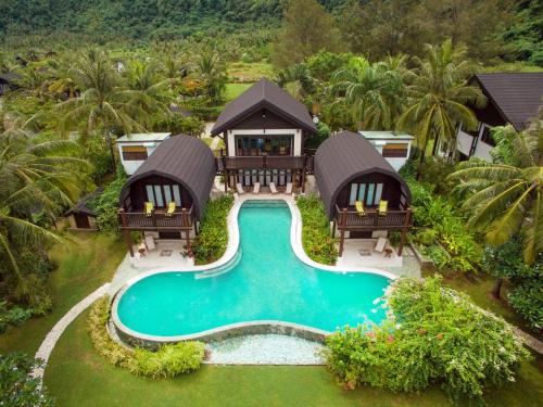 an aerial view of a resort with a swimming pool at Kudat Riviera Exclusive Beach Villas in Kudat