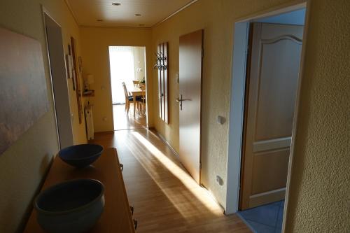 a hallway with a door to a room with a table at Ferienwohnung Lindlar-Linde in Lindlar