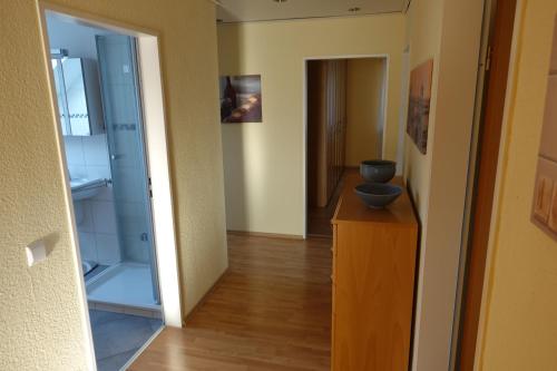 a hallway with a refrigerator and a wooden dresser at Ferienwohnung Lindlar-Linde in Lindlar
