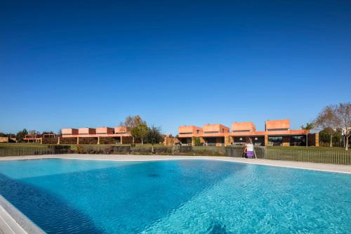 a large swimming pool in front of a building at L Orangerie CA by Intiholidays in Vilamoura