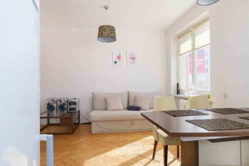 a living room with a couch and a table at Apartament Libelta in Poznań