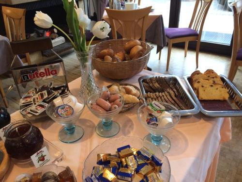 a table topped with plates of food and desserts at Hotel garni Fuchs in Eichstätt