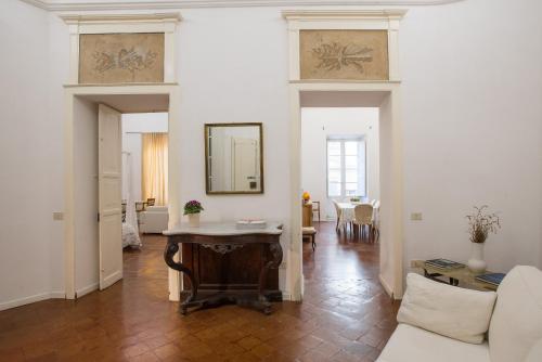 a living room with a table and a couch at Residenze al Castello Apartments in Cagliari
