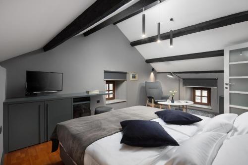 a bedroom with a large bed with two pillows at Rialto Residence in Labin