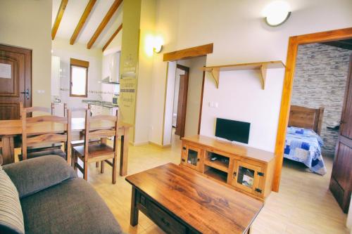 a living room with a couch and a table at Apartamentos La Fuente de Enmedio in Suances