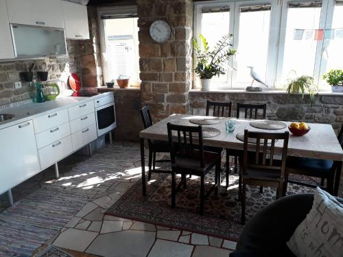 a kitchen with a table and chairs in a room at Punta Nana Mira in Piran