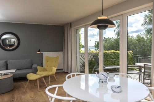 a living room with a table and chairs at Im-Jaich Wasserferienwelt in Lauterbach