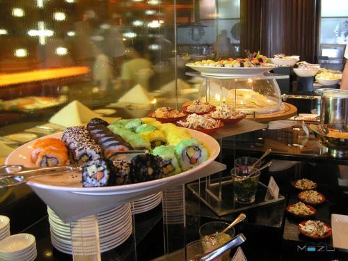 a plate of pastries on a table with other desserts at lebua at State Tower in Bangkok