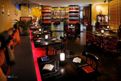 a restaurant with tables and chairs and a bar at lebua at State Tower in Bangkok