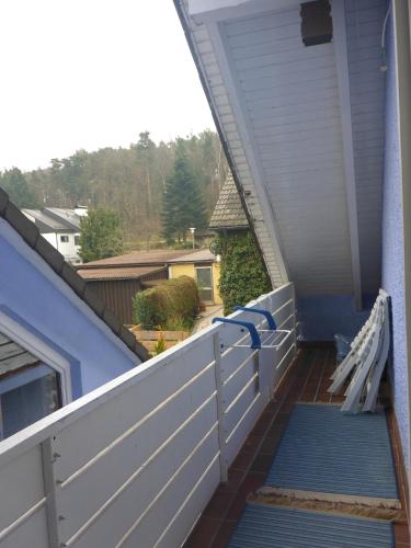 a porch with blue steps and a white fence at Ferienwohnungen Lichtblick und Sonneck in Hilpoltstein