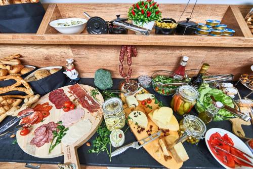 a table topped with different types of food and snacks at Perla Residence Hotel & SPA in Podgorica
