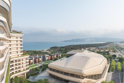 an aerial view of a building with the ocean in the background at Van-Pretty Residence Haitang Bay Sanya in Sanya