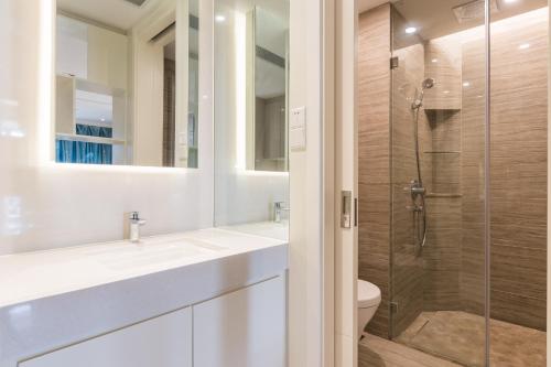 a bathroom with a sink and a shower at Van-Pretty Residence Haitang Bay Sanya in Sanya