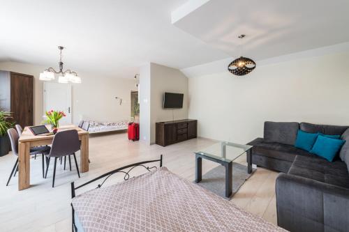 a living room with a couch and a table at Lake & City Apartments in Giżycko