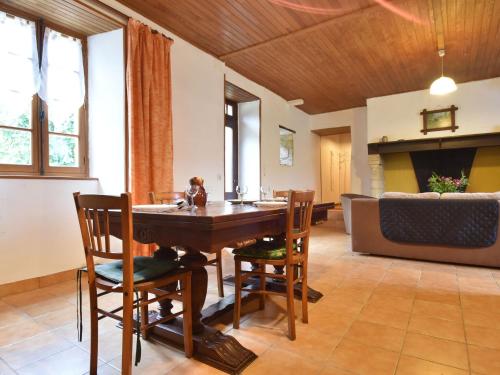 a dining room with a wooden table and chairs at Scenic Home in Berbiguières in Saint-Germain-de-Belvès