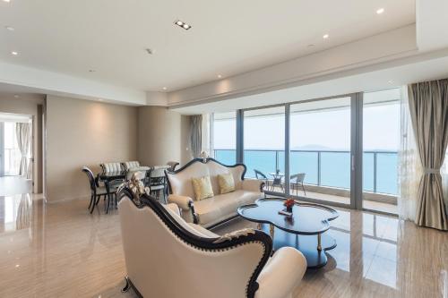 a living room with a couch and a table at Van-Pretty Residence Haitang Bay Sanya in Sanya
