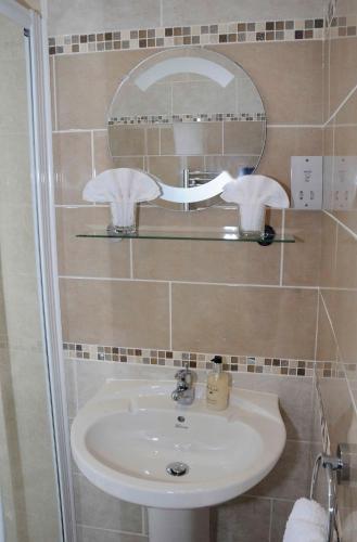 a bathroom with a sink and a mirror at Douglas House in Castle Douglas