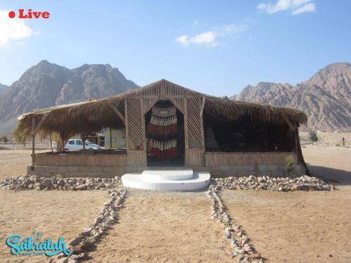 a building in the desert with a frisbee in front at SakraTah Camp - eco friendly in Taba