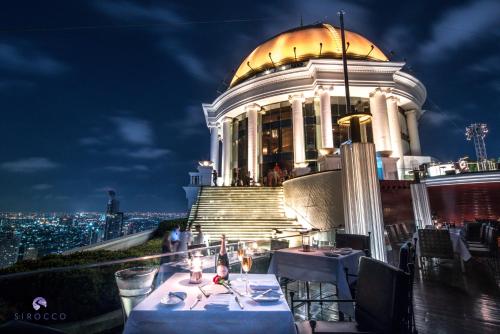 a restaurant on top of a building at night at lebua at State Tower in Bangkok