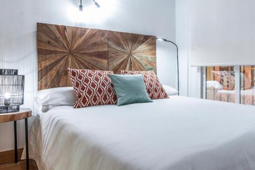 a bedroom with a large white bed with pillows at O'Donnell in Madrid