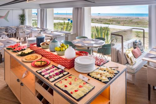 a buffet with food on a table in a restaurant at Bel Air in Castelldefels