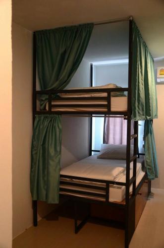 two bunk beds in a room with a mirror at Best Stay Hostel At Lanta in Ko Lanta