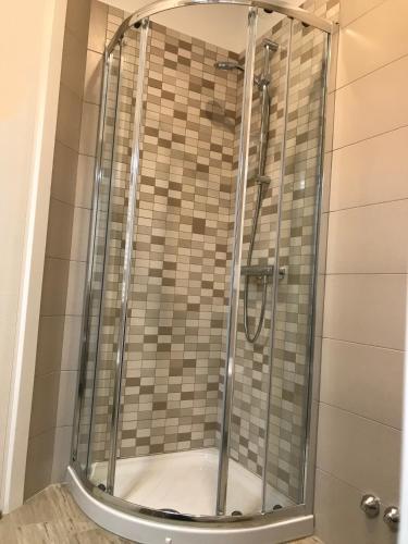 a shower with a glass door in a bathroom at A Matera "Sotto i pini" in Matera