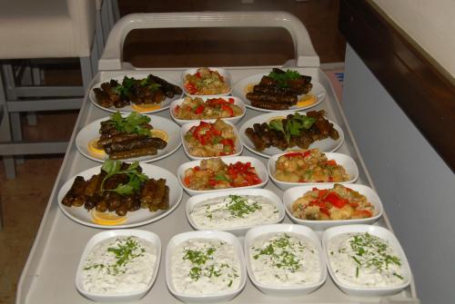a tray filled with plates of food on a table at Belle Ocean Apart Otel in Alanya