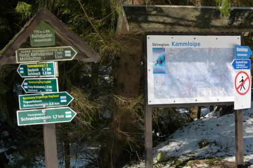 a street sign with several signs in the snow at Ferienwohnung KaRo in Ellefeld