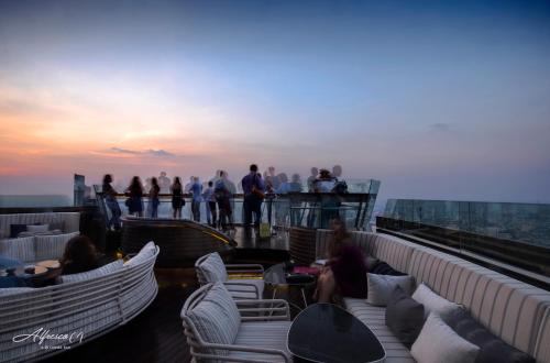 a group of people sitting on the top of a building at Tower Club at lebua in Bangkok