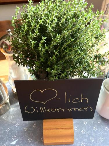 a sign on a table in front of a plant at Bürger- und Berggasthaus Scheibenberg in Scheibenberg