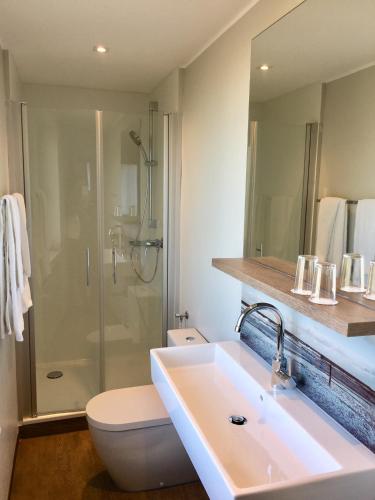 a bathroom with a sink and a toilet and a shower at Straelener Hof in Straelen