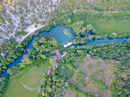 an overhead view of a river and a forest at Moulin de Latreille in Calès