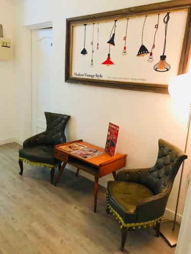 a room with two chairs and a table and a mirror at Hostal Portugal in Barcelona