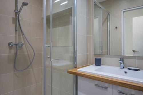 une salle de bain avec douche et lavabo dans l'établissement Vintage, F3 avec terrasse, Villa Saint Charles, à Paris