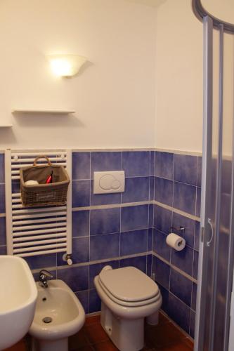 a blue tiled bathroom with a toilet and a sink at La Locanda Del Podestà Cinque terre in La Spezia