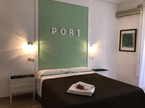 a bedroom with a bed with a sign on the wall at Hostal Portugal in Barcelona