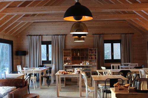 a dining room with tables and chairs and windows at Piedrafita Mountain in Piedrafita de Jaca