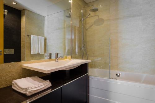 a bathroom with a sink and a shower at Pretty Porto Apartment by SOULSHARING.PORTO in Porto