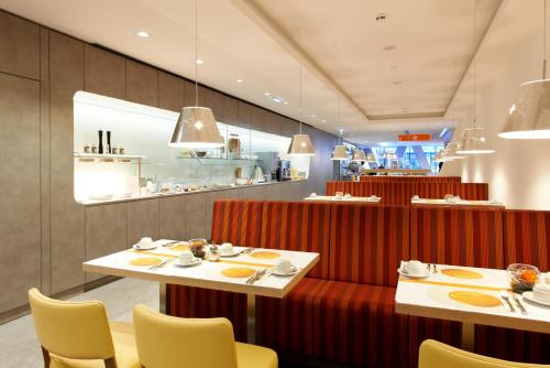 a restaurant with two tables and chairs and a counter at Simm's Hotel - cityhotel next to Metro U3 in Vienna