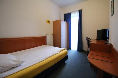 En eller flere senge i et værelse på Hotel Ahrberg Viertel
